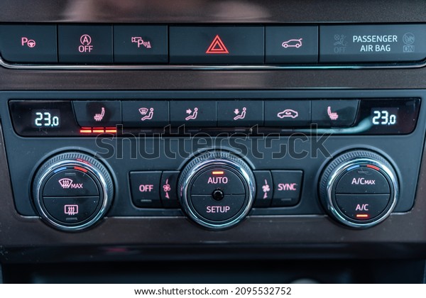 Cluj-Napoca, Cluj-Romania-12.01.2021-Dual climate\
panel unit inside Seat Ateca SUV. The tempera control unit, seat\
heating switch, heated steering wheel, hazard button, auto\
start-stop, electric\
trunk