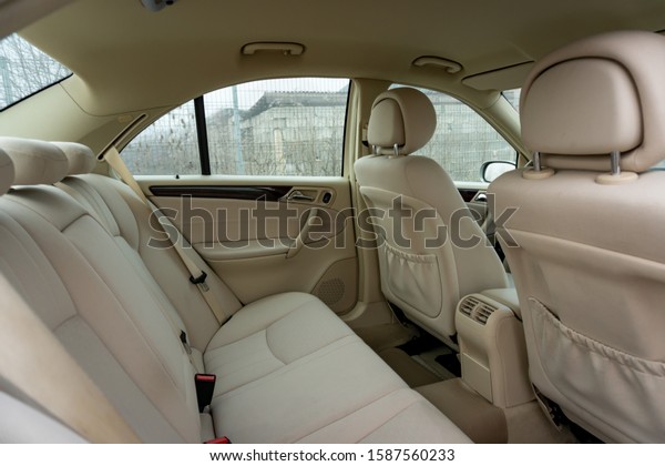 Cluj-Napoca, Cluj/Romania-12.12.2019-Beige clean\
upholstery inside a beautiful german classic car - Mercedes Benz C\
Class, type w203-year 2005, Elegance equipment. Isolated car in an\
empty parking lot