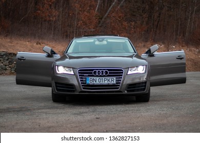 Cluj-Napoca, Romania-February 14, 2019 :Close up photo of front side Audi A7 sports car with matrix led headlights,quatro emblem,black privacy windows and chrome ornaments.Open doors, isolated car