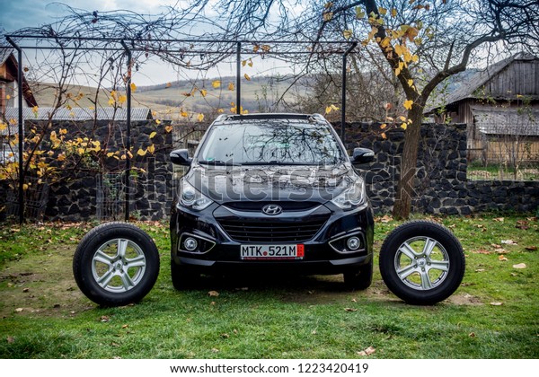 Cluj-Napoca, Romania-November 02, 2018 : Hyundai\
Tucson - IX 35 4wd, SUV 4x4, all terrain car. Alloy wheels,\
panoramic sunroof. Reverse camera, automatic gear, parking sensors\
- isolated in sunny\
day