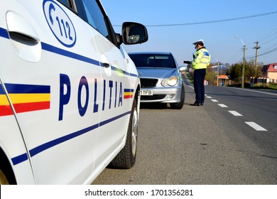 Cluj-Napoca,Cluj/Romania-04.12.2020-Police Agent, Romanian Traffic Police (Politia Rutiera) Driving License And Car Papers Check. During COVID 19 Pandemic,  All Papers Are Presented On The Car Window