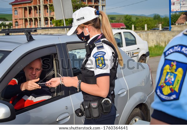 Cluj-Napoca,Cluj/Romania-09.06.2020-Police agent,\
Romanian Traffic Police (Politia Rutiera) traffic filter on DN1E60.\
Police constable stopping cars for control. Close up\
photo