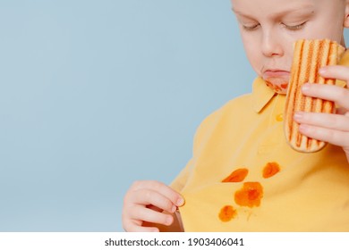  Clumsy Child Staining Her Shirt With Ketchup Sauce. Child Ruining Her T-shirt With Tomato Sauce Eating Hot Dog