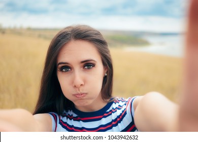 Clumsy Girl Trying To Take A Selfie In Nature. Funny Girl Taking Too Close Bad Angle Self Portraits 
