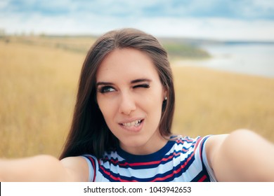 Clumsy Girl Trying To Take A Selfie In Nature. Funny Girl Taking Too Close Bad Angle Self Portraits 
