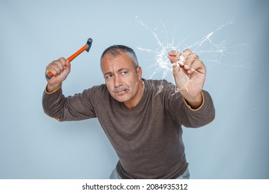 Clumsy Man Drives A Nail With A Hammer Into The Glass