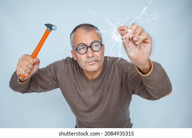 Clumsy Man Drives A Nail With A Hammer Into The Glass