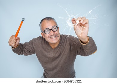 Clumsy Man Drives A Nail With A Hammer Into The Glass