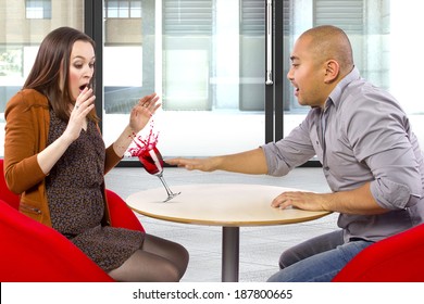 Clumsy Man Spilling A Drink On His Date