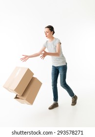 Clumsy Young Woman Dropping Moving Boxes And Tripping. On White Background