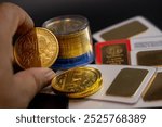 cluse-up hand counting gold coins on a back table with more gold. business, investments, finance and savings. Stock photo