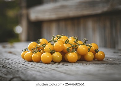 Cluster of ripe yellow cherry tomatoes on a wooden surface - Powered by Shutterstock