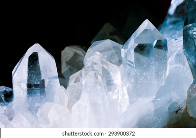 Cluster Of Rock Crystals Or Pure Quartz, A Clear Macrocrystalline Variety Of Silica (SiO2) Isolated On Black Background. This Gemstone Is Said To Have Strong Healing Power. Birthstone For April