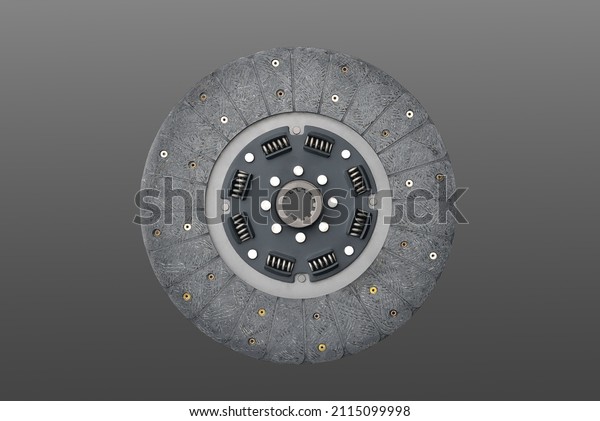 Clutch disc, car clutch disc,\
car transmission, gray background backdrop, close-up selective\
focus