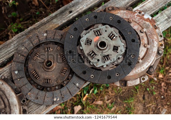 Clutch discs on\
a wooden background, car\
repair.