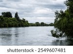 Clutha river in New zealand wide surrounded by trees landscape