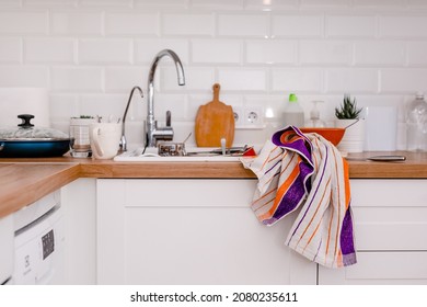 Clutter, Dirty Dishes By The Sink In The White Kitchen.