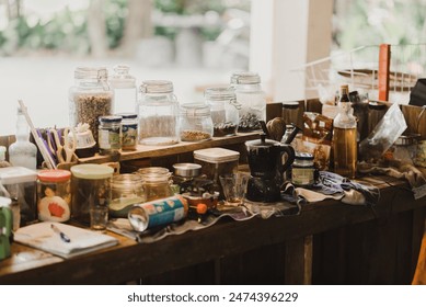 A cluttered rustic kitchen workspace with jars, spices, utensils, and bottles. Perfect for cozy, homey, and earthy-themed designs or DIY cooking and crafting events.