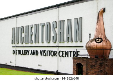 Clydebank, Scotland - August 21 2016: Auchentoshan Whisky Distillery Building With Lettering And An Old Copper Still