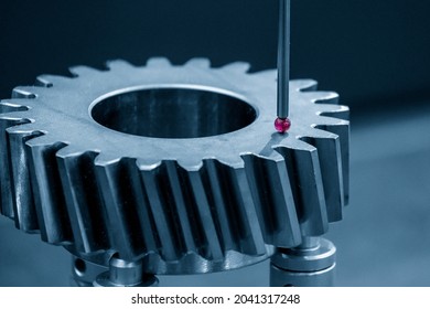 The CMM Probe Measuring The Metal Bevel Gear Part. The Quality Control Of Automotive Parts With CMM Machine.