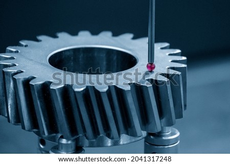 The CMM probe measuring the metal bevel gear part. The quality control of automotive parts with CMM machine.