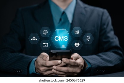 CMS, Content management system concept. Businessman using smartphone with virtual screen of content management system icon for business website management.