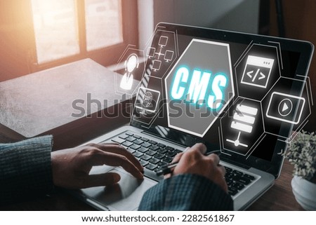 CMS, Content management system concept, Person hand using laptop computer with Content management system icon on virtual screen background, business web computer website administration.