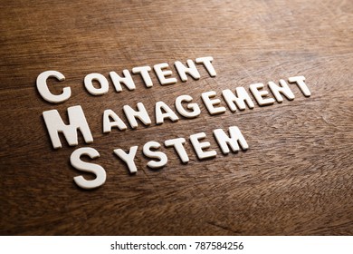 CMS (Content Management System) text by wood letters on wood texture