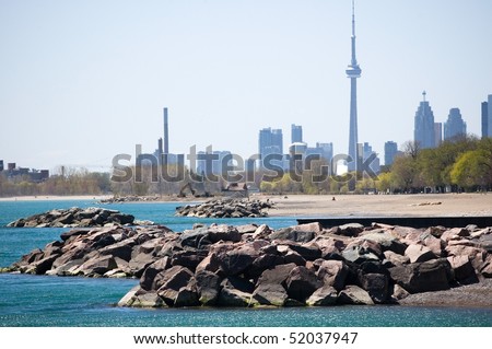 CN tower , the beaches - famous place of toronto , sea and sky background
