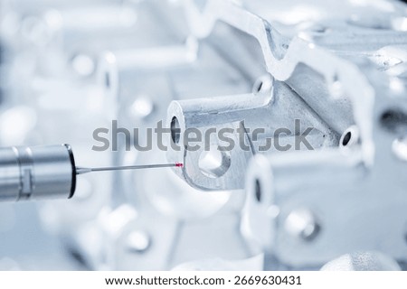 Cnc coordinate measuring machine inspecting engine component.
