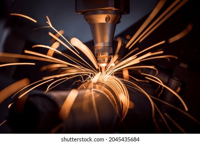 CNC Laser cutting of metal, modern industrial technology Making Industrial Details. The laser optics and CNC (computer numerical control) are used to direct the material or the laser beam generated. - Shutterstock ID 2045435684