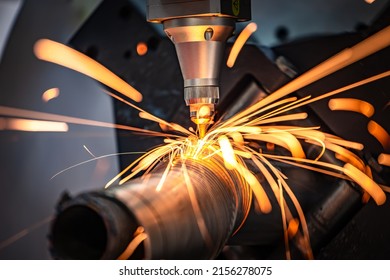 CNC Laser cutting of metal, modern industrial technology Making Industrial Details. The laser optics and CNC (computer numerical control) are used to direct the material or the laser beam generated. - Shutterstock ID 2156278075