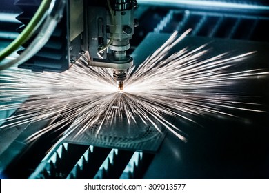 CNC Laser cutting of metal, modern industrial technology. Small depth of field. Warning - authentic shooting in challenging conditions. A little bit grain and maybe blurred. - Powered by Shutterstock