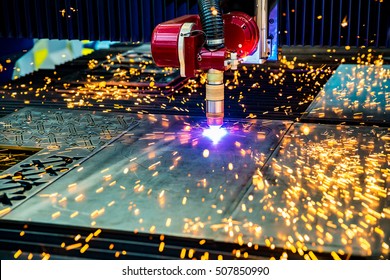 CNC Laser plasma cutting of metal, modern industrial technology. Small depth of field. Warning - authentic shooting in challenging conditions. A little bit grain and maybe blurred.