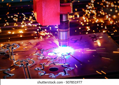 CNC Laser plasma cutting of metal, modern industrial technology. Small depth of field. Warning - authentic shooting in challenging conditions. A little bit grain and maybe blurred.