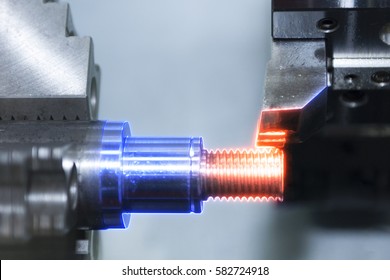 The CNC lath of CNC Turning machine cutting the thread with the abstract lighting effect scene