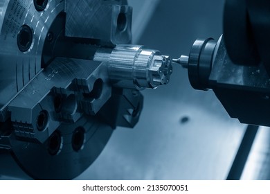 The  CNC lathe machine chamfering cut the metal shape parts. The hi-technology metal working processing by CNC turning machine . - Shutterstock ID 2135070051