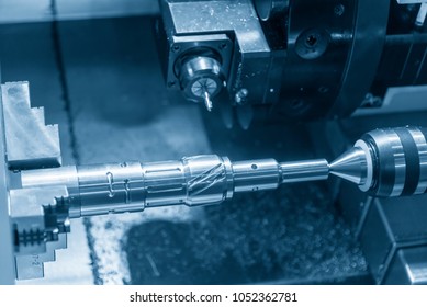 The CNC lathe machine cutting the metal rod by milling spindle. 