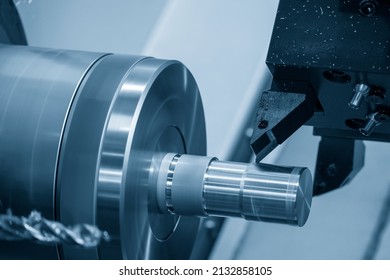 The  CNC lathe machine forming  cutting the metal shaft parts. The hi-technology metal working processing by CNC turning machine . - Shutterstock ID 2132858105