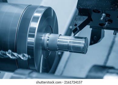 The  CNC lathe machine forming  cutting the metal shaft parts. The hi-technology metal working processing by CNC turning machine .
