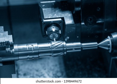 The CNC lathe machine slot cutting by the milling turret. Hi-technology automotive part manufacturing process on turning machine.