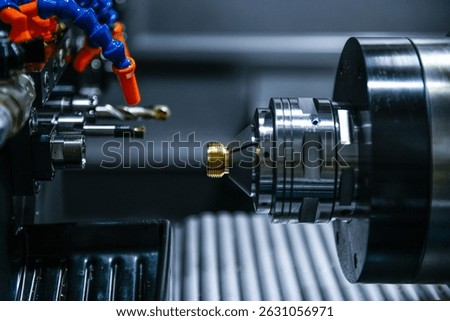 The CNC lathe machine thread cutting the screw metal shaft parts