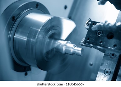 The  CNC lathe machine or turning machine  cutting the thread at the steel shaft.The threading process on the CNC lathe machine .