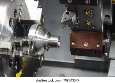 CNC lathe machine (Turning machine) cutting the metal  screw thread part .Hi-precision CNC machining concept. - Shutterstock ID 709543579