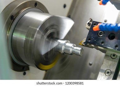The CNC lathe or turning machine cutting  the thread  at the metal shaft.Hi-technology manufacturing process.
