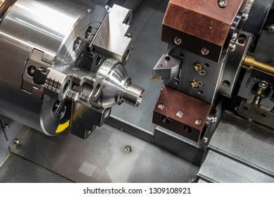The CNC lathe or turning machine cutting  the thread  at metal cone shape parts.Hi-technology manufacturing process. - Shutterstock ID 1309108921