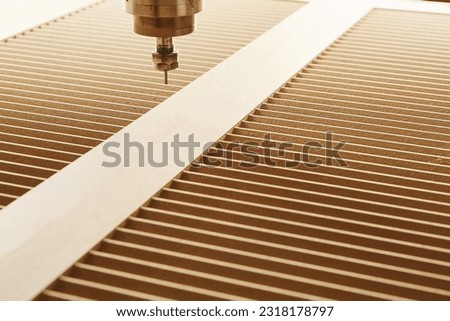 Cnc machine at carpentry workshop. Cutting wood with various router bits.