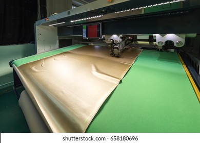 CNC machine for cutting fabrics and leather. Modern footwear production.