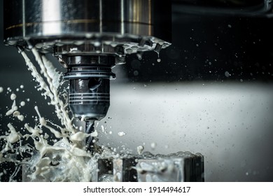 CNC machine drilling holes with carbide drill and coolant being used - Shutterstock ID 1914494617