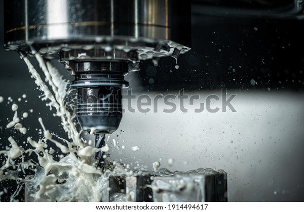 CNC machine drilling holes with carbide drill and\
coolant being used